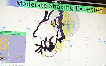 Monitor screen showing a map and the words Moderate Shaking Expected