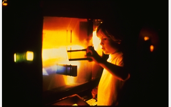 Child plays with colored filters in the "Distilled Lights" exhibit at San Francisco Explor