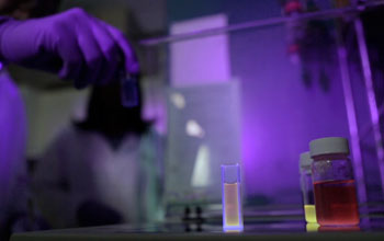 hand holding test tube in a  lab