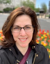 Woman standing in front of flowers