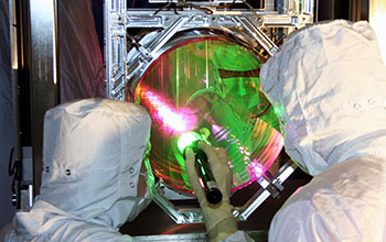 Technicians examine one of LIGO's mirrors
