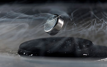 Magnet floats above superconductor cooled with liquid nitrogen