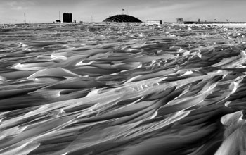 Dome at Amundsen-Scott framed by ridges of snow called sastrugi