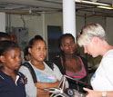 Photo of oceanographer Lisa Beal showing schoolchildren a current meter.