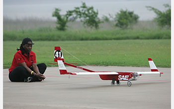 Photo of a student and a plane taking off.