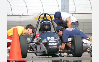 Photo of students working on their vehicle during SAE International's Formula SAE® competition.