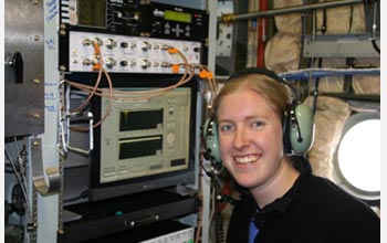 Photo of scientist Kerri Pratt inside an NSF C-130 aircraft, tracking cloud particles.