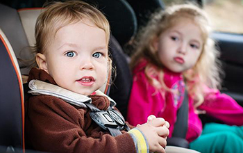 Two young kids in a car