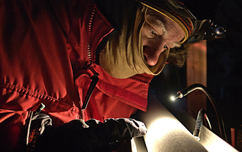 Photo of scientist examining an ice core.