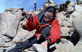 Johns Hopkins graduate student Karina Zavala breaks up a sample of igneous rock for study