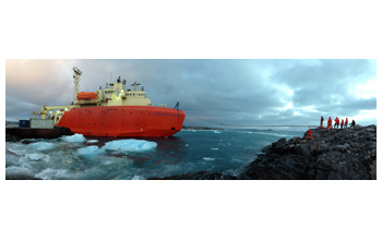 Palmer Station personnel, serving as line handlers, untie the research vessel LAURENCE M. GOULD