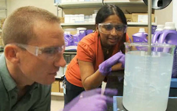 Anita Kalathil with colleague in chemical lab