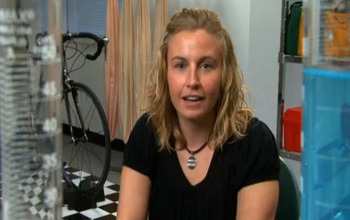 Scientist facing camera with bike and other equipment in background