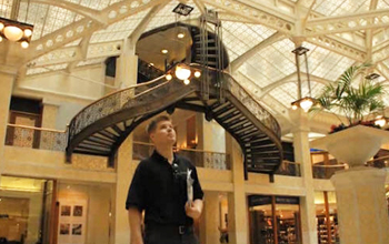 Ken Maschke in a building lobby under skylights and staircase