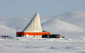 a drilling platform and a container holding generators on the ice cover of Lake E.