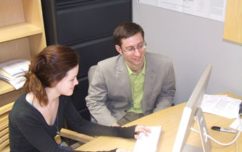 Photo of scientists Jacob Sewall and Elizabeth Heness analyzing climate change simulations.