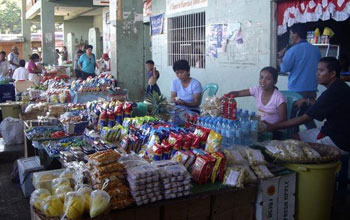 Photo of vendors selling their goods at an open air market in the Philippines.