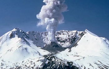 Ash plume from snow capped volcano