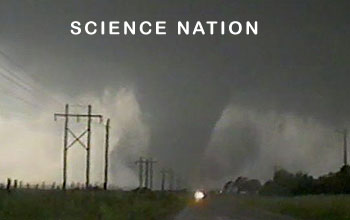 Still image of a tornado seen from a road