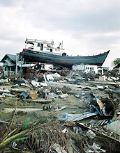 A boat sits atop a house in Banda Aceh province