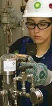 worker with BP hardhat checking gauges