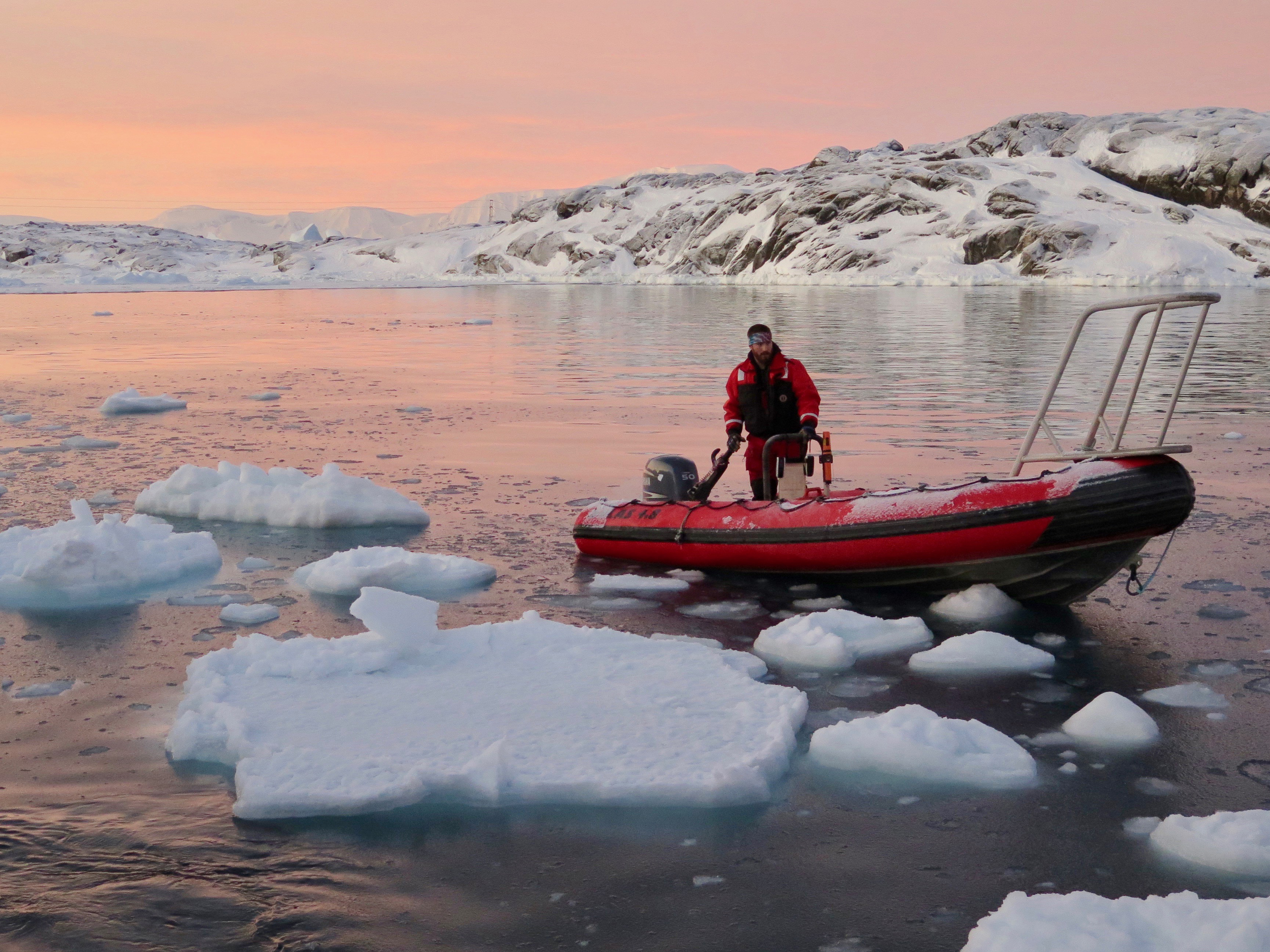 man in boat in antarctica